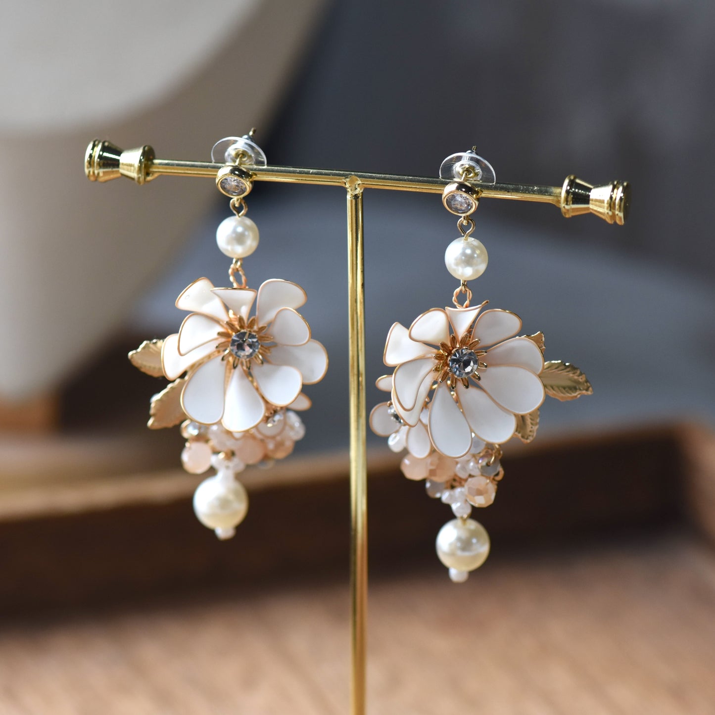 Odette handcrafted white ivory resin floral drop earrings pearl crystal champagne gold on jewellery stand
