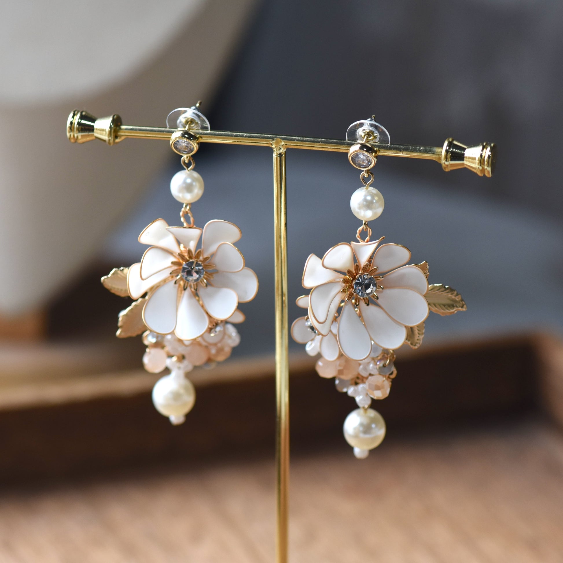 Odette handcrafted white ivory resin floral drop earrings pearl crystal champagne gold on jewellery stand
