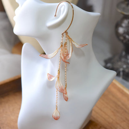 Close-up of Raziel handcrafted floral ear cuff highlighting glossy resin petals, pearl bead chains and intricate gold wire finish