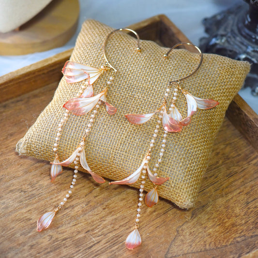 Raziel handcrafted floral resin ear cuff with cascading blush pink and ivory petal drops, pearl bead chains and soft gold detailing