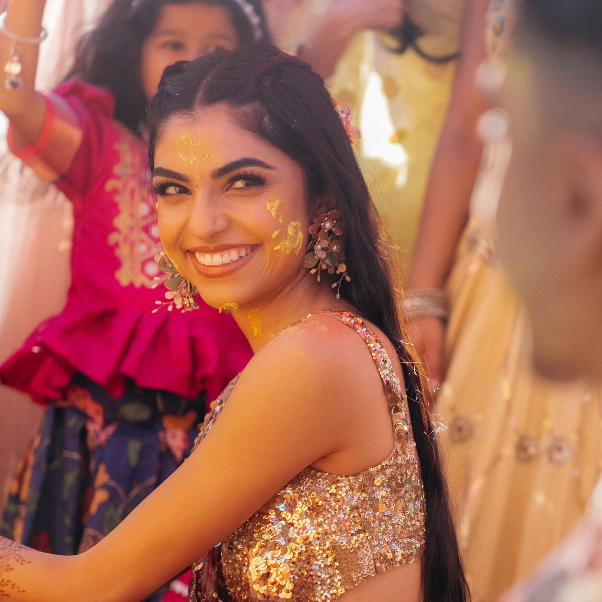 Real bride wearing Reine blush resin floral earrings at her haldi ceremony
