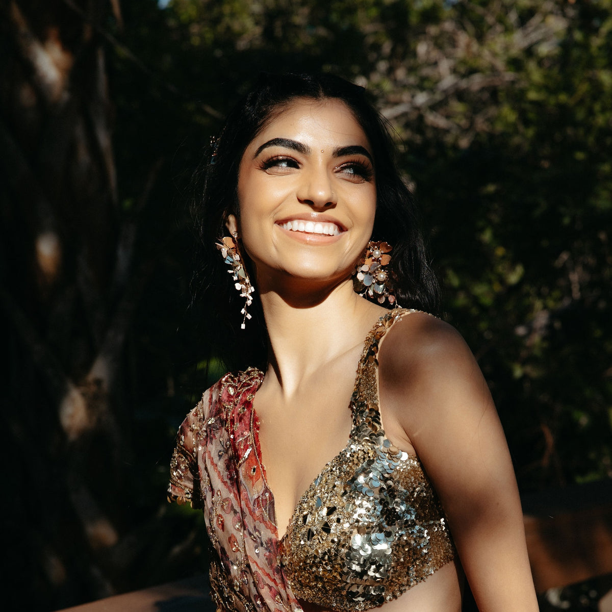 Real bride wearing Reine blush and blue floral statement earrings with a sequinned lehenga
