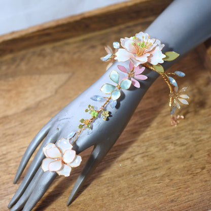 Close up of Sadie floral hand harness with resin flowers and botanical detailing