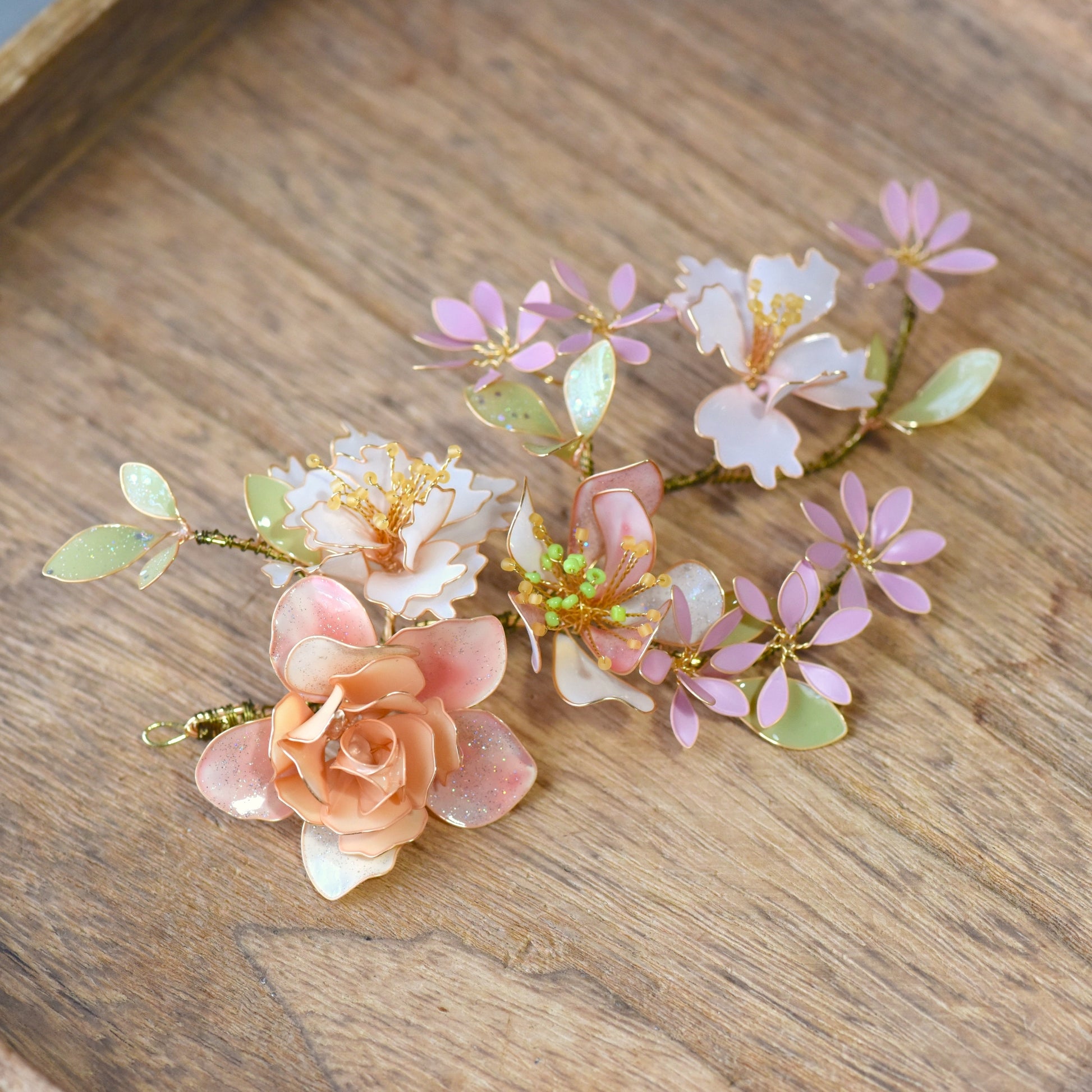 Sadie floral hair accessory with handcrafted resin flowers in blush pink, ivory and sage green, finished with soft gold wire detailing