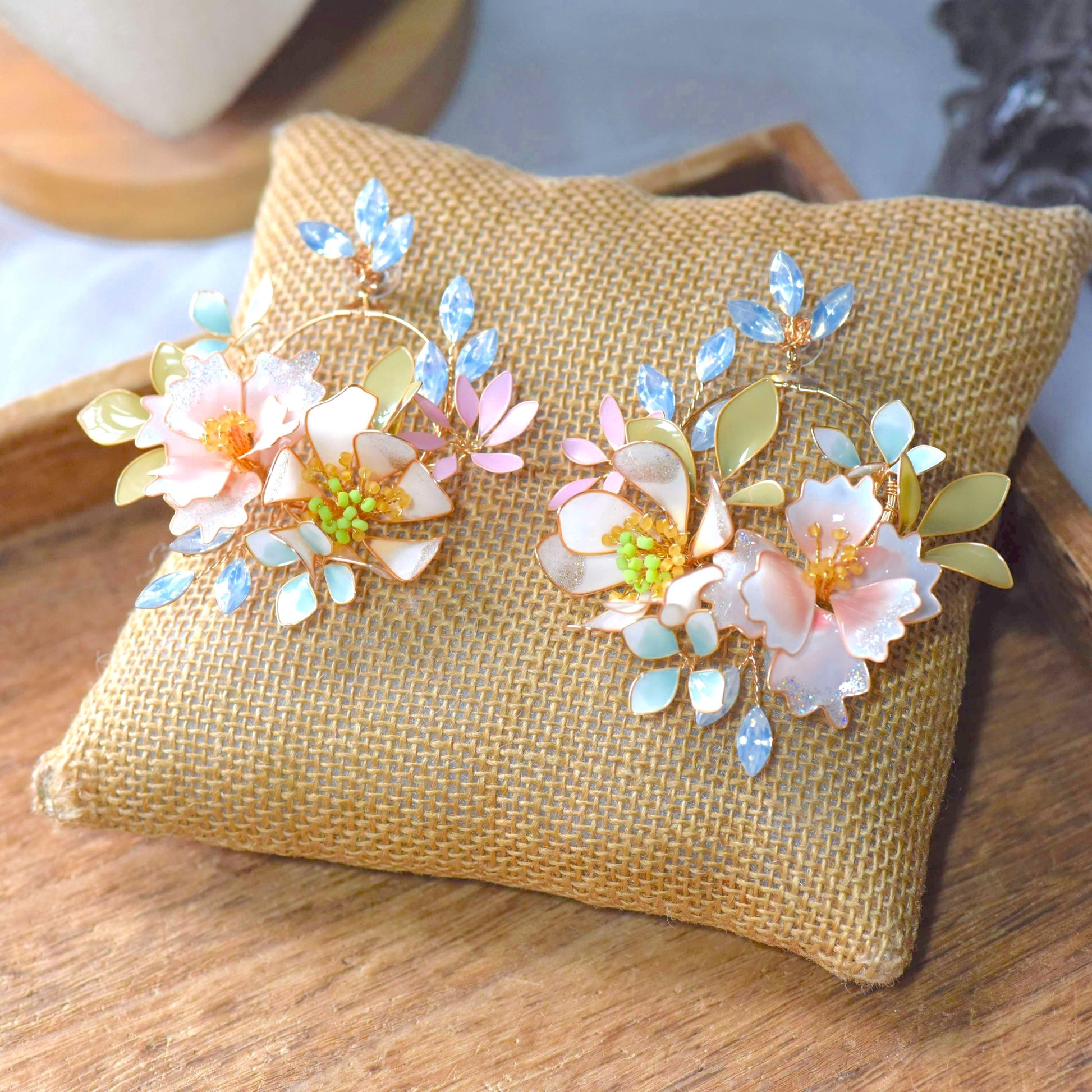 Sadie handcrafted pastel resin floral hoop earrings blush pink lavender powder blue mint gold crystal flat lay burlap
