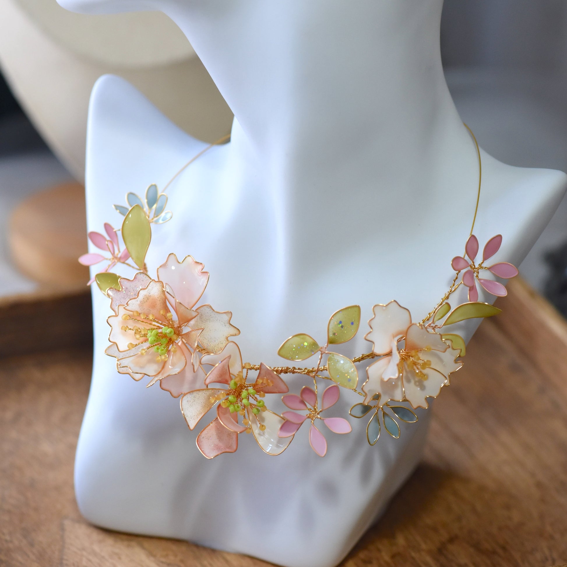 Side view of Sadie floral resin necklace showcasing pastel flower detailing, soft gold wirework and handcrafted design