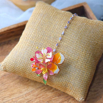 Samara handcrafted resin floral maang tika blushing pink orange gold glass beads on burlap cushion