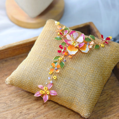 Samara handcrafted resin floral haath phool hand harness vibrant pink coral orange green gold flat lay