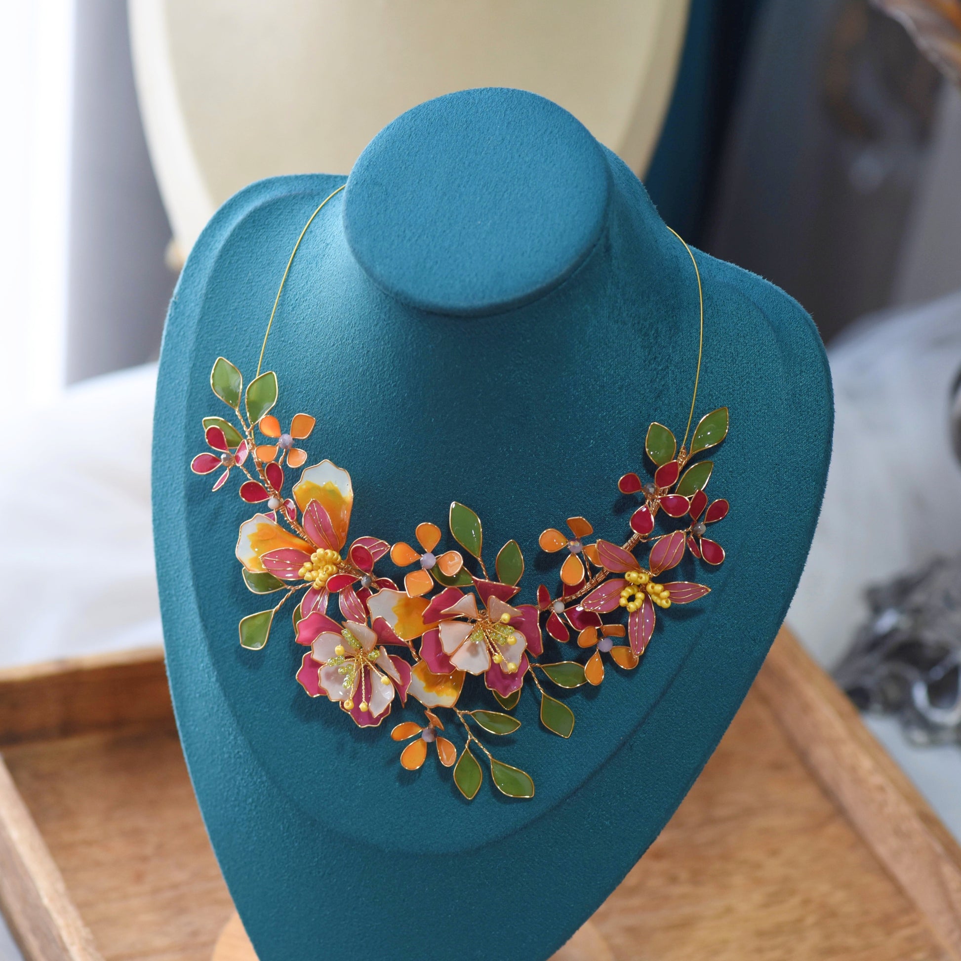 Samara handcrafted resin floral necklace vibrant pink orange green gold on bust botanical statement jewellery