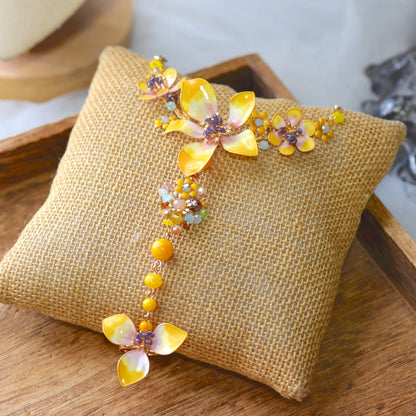 Seraphina handcrafted resin floral haath phool hand harness yellow peach lavender violet beads flat lay burlap