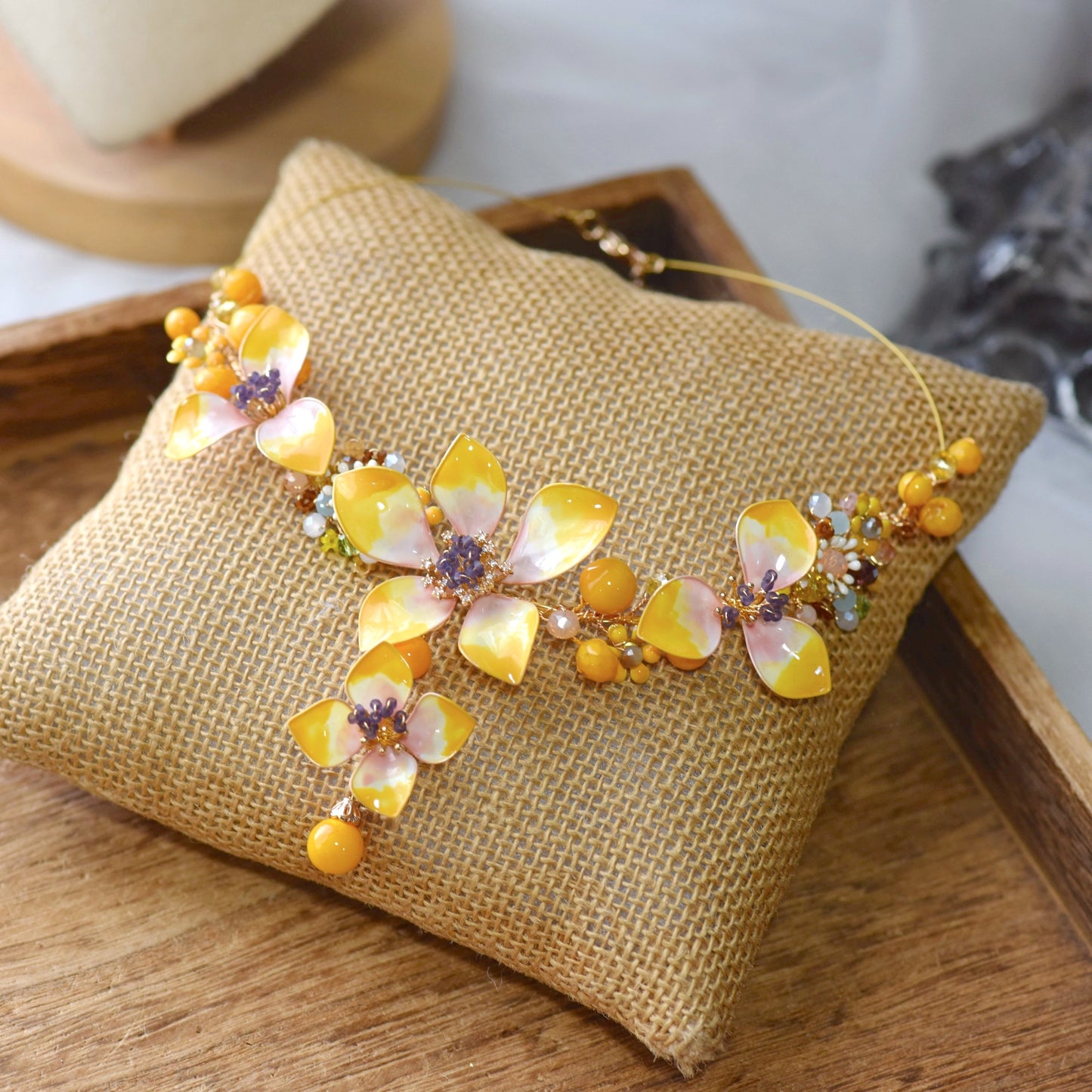 Seraphina handcrafted resin floral necklace yellow peach lavender violet beads ivory amber flat lay burlap