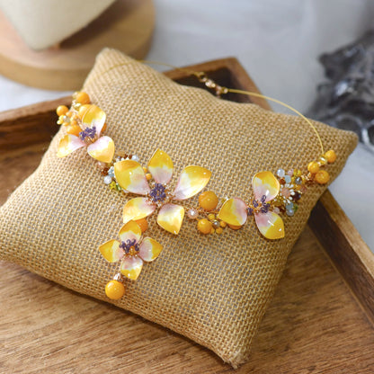 Seraphina handcrafted resin floral necklace yellow peach lavender violet beads ivory amber flat lay burlap