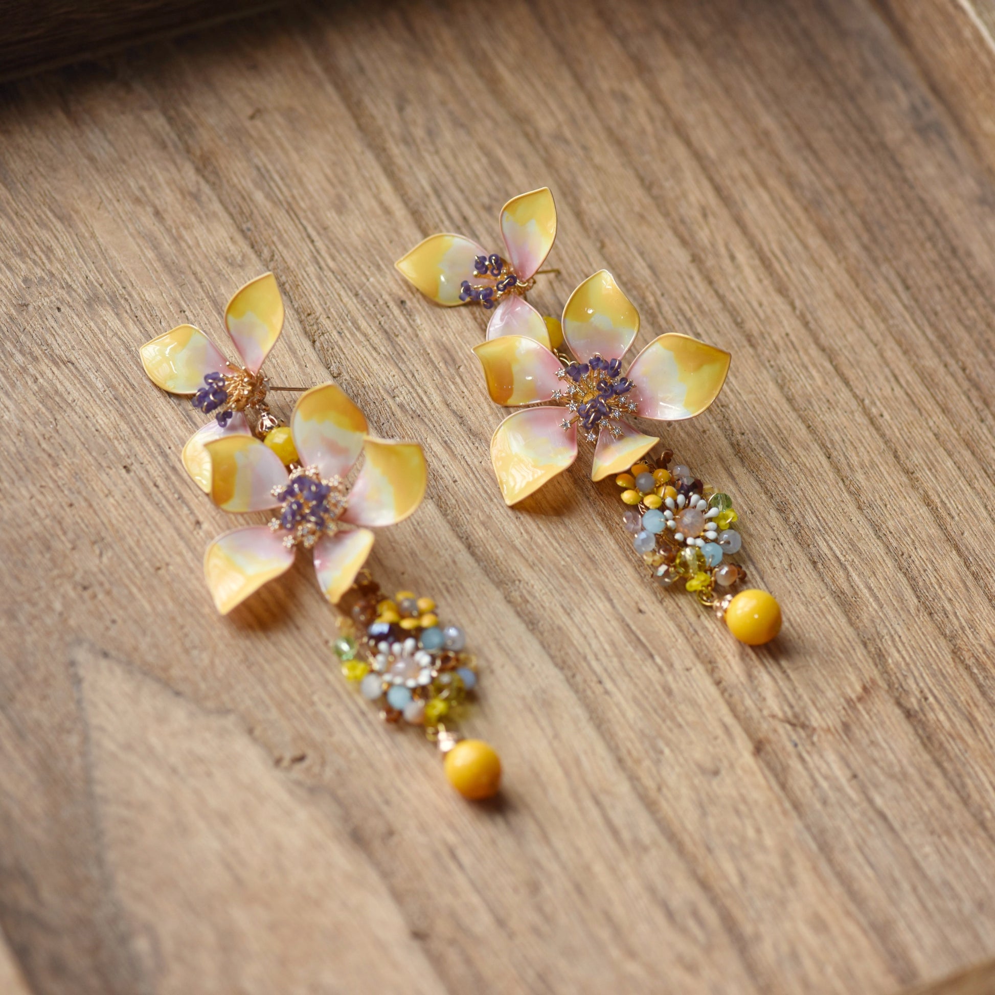 Close-up Seraphina resin floral drop earrings yellow peach copper wirework ivory amber blue honey violet beads