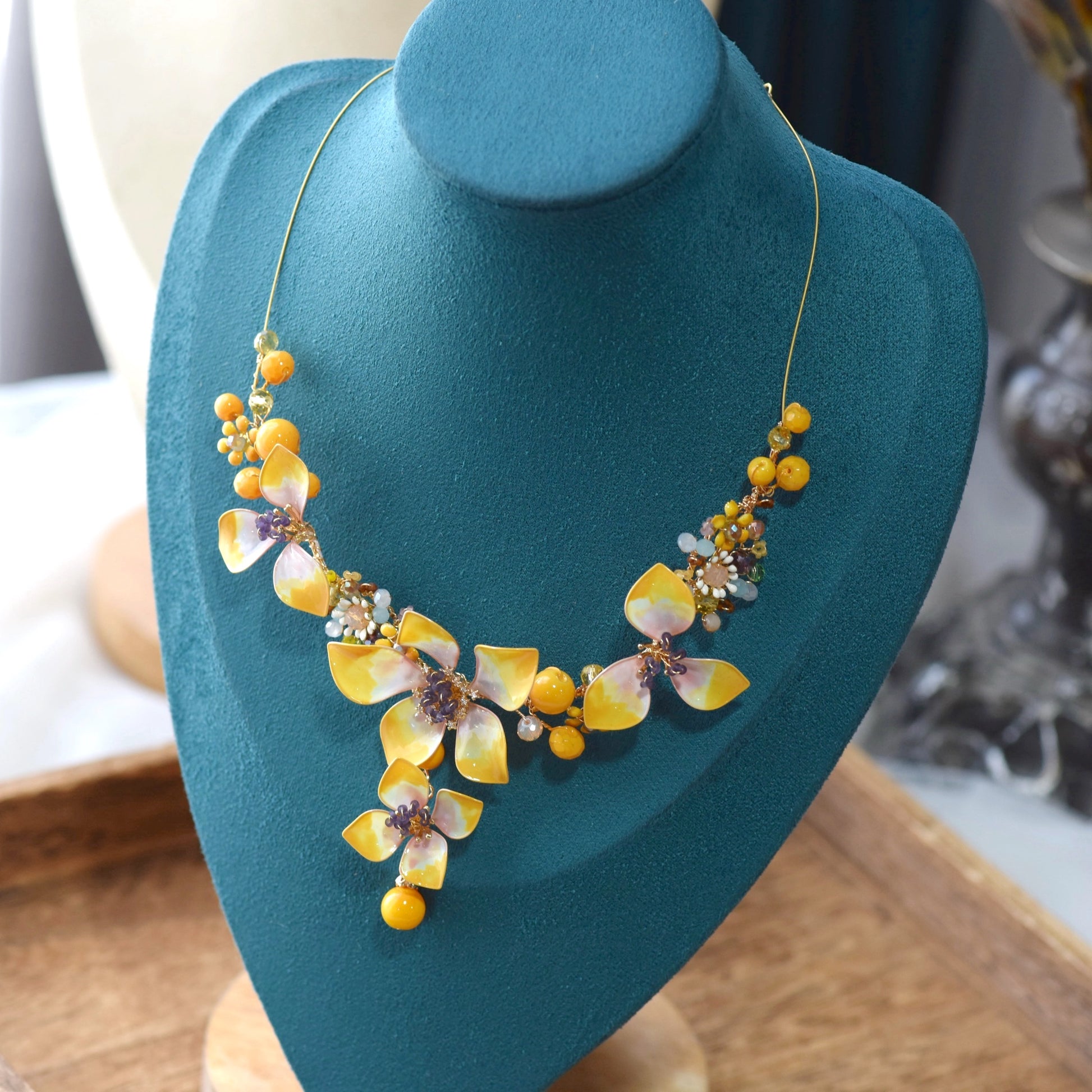 Seraphina handcrafted resin floral necklace yellow peach lavender beaded centres on teal bust