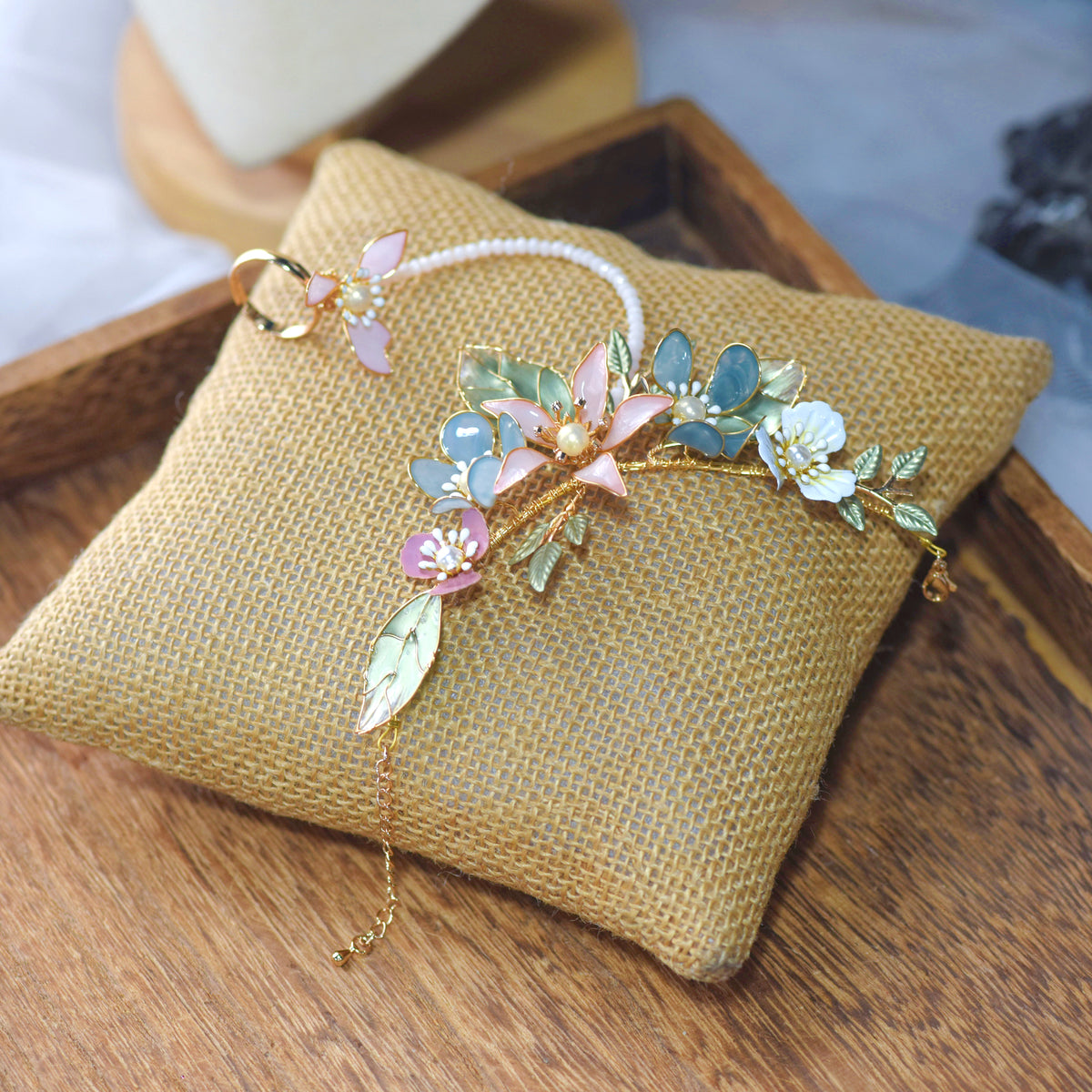 Close view of the Shaylah hand harness showing pastel resin blooms along a fine golden vine
