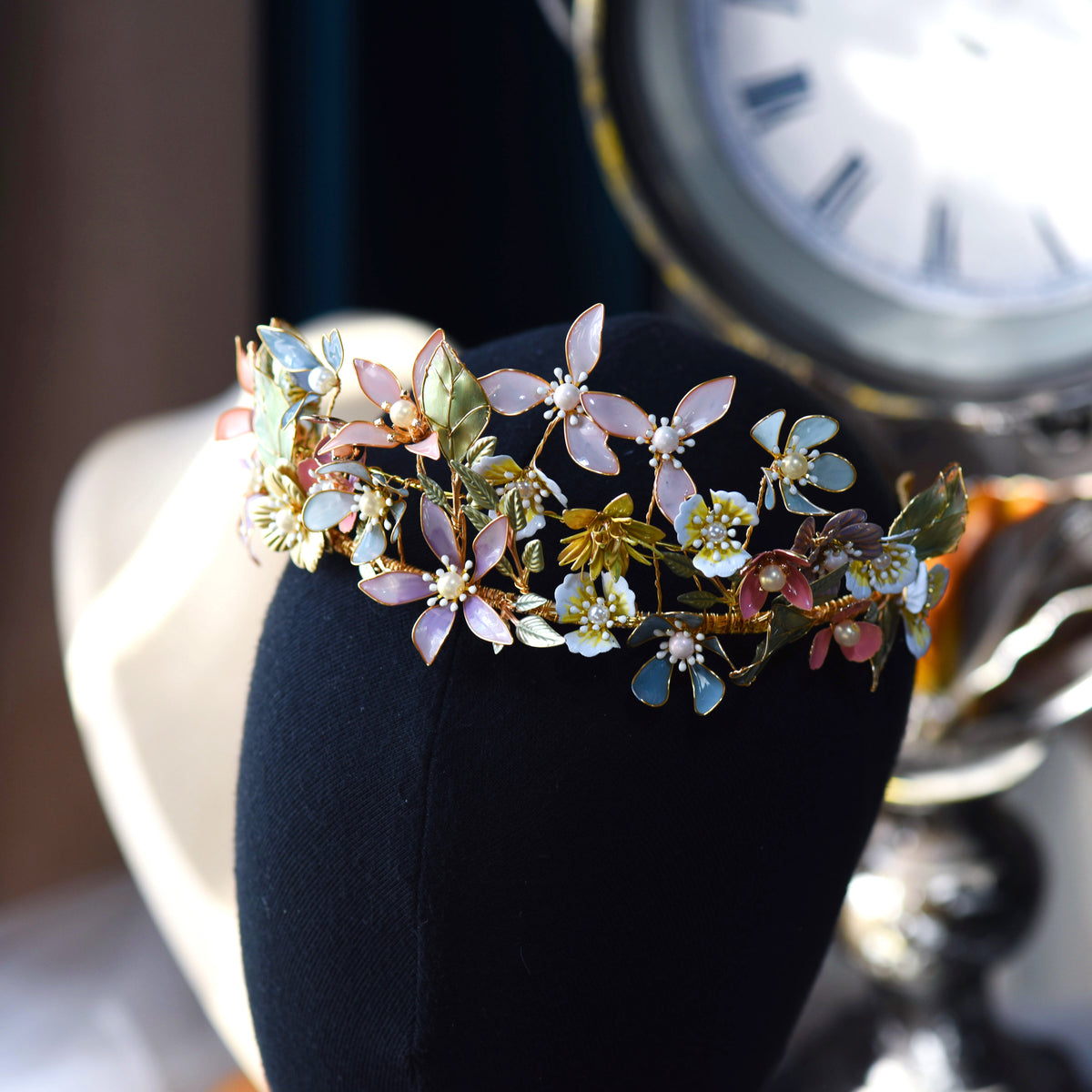 Shaylah pastel floral headband displayed on a dark stand showing the full crown of blooms
