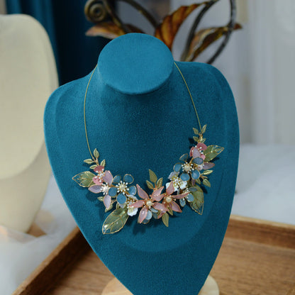 Shaylah pastel floral statement necklace displayed on a stand showing the central bloom cluster
