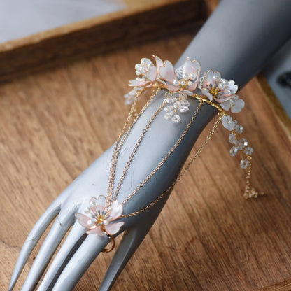 Sophia white and pearl floral haath phool on a display hand showing the wrist-to-finger vine

