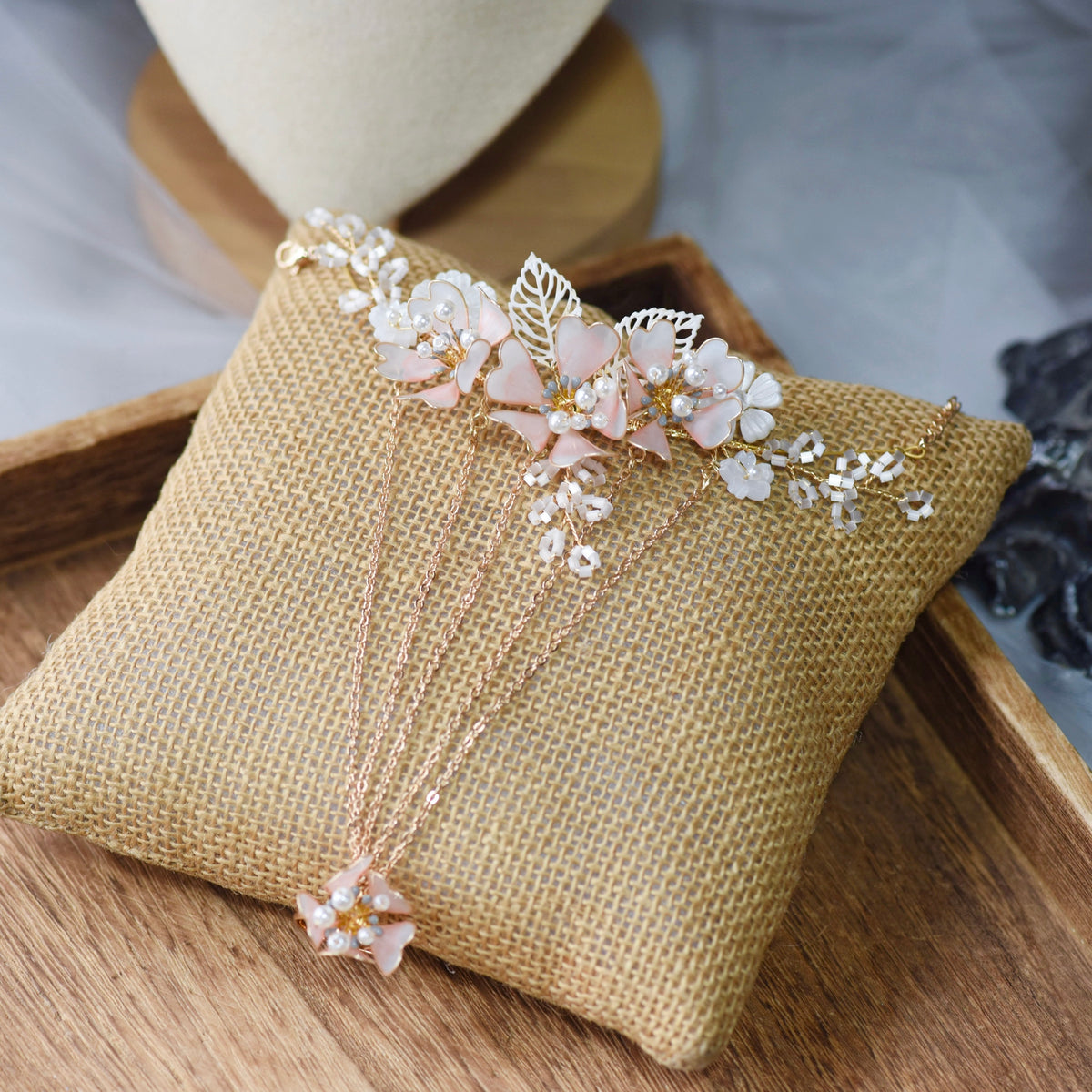 Sophia white resin floral hand harness with imitation pearls laid on a jute cushion
