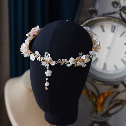 Sophia white and pearl resin floral head harness displayed on a stand showing the full vine
