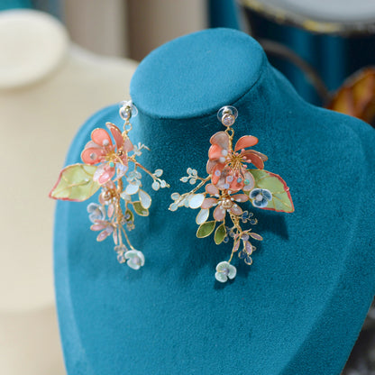 Trina coral resin floral earrings displayed on a stand showing the garden cluster design
