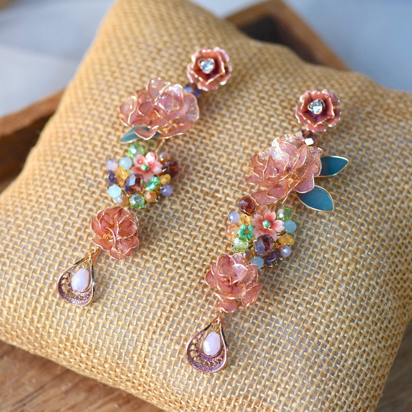 Venetia handcrafted rose gold copper resin rose floral drop earrings multicolour crystal beads moonstone flat lay burlap
