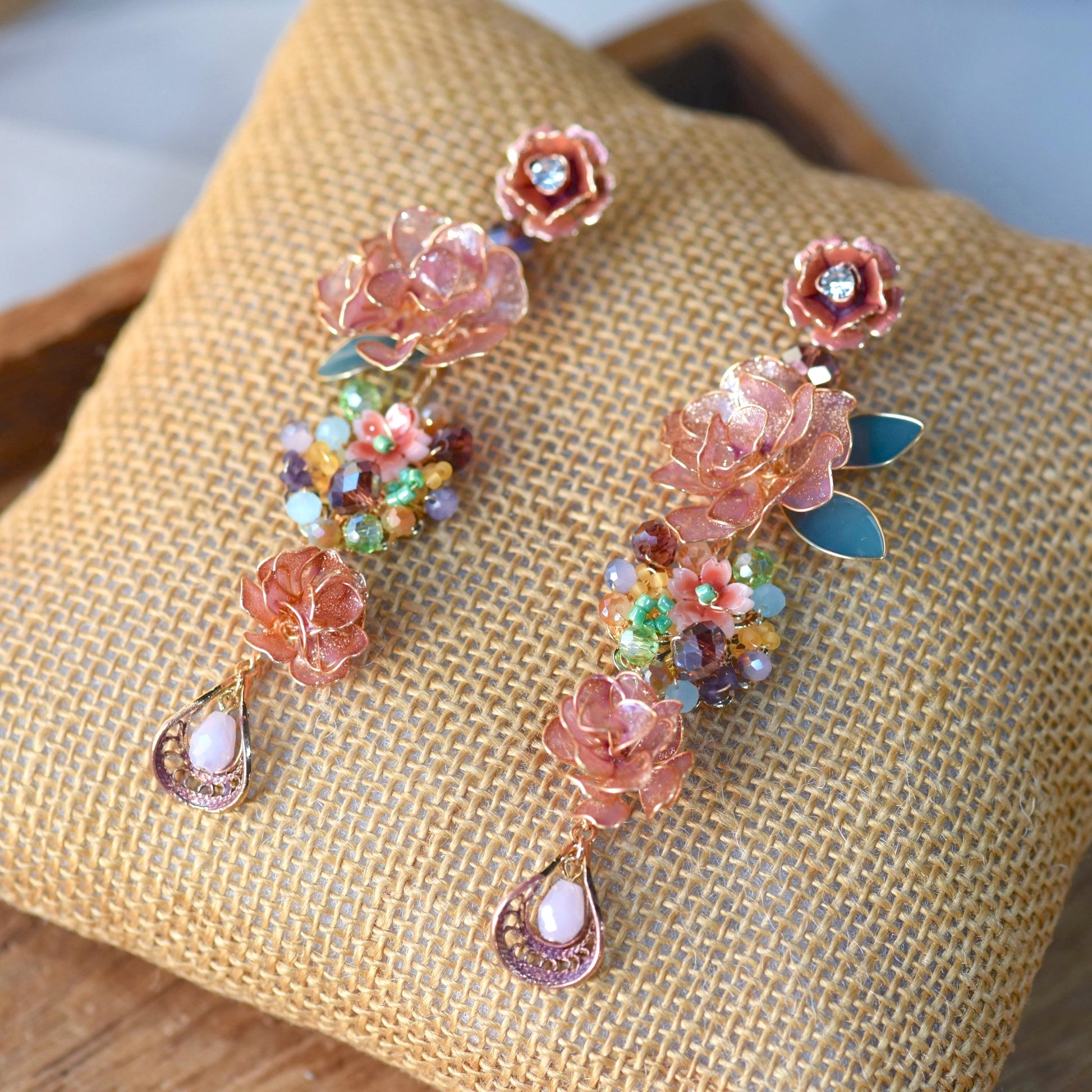Venetia handcrafted rose gold copper resin rose floral drop earrings multicolour crystal beads moonstone flat lay burlap
