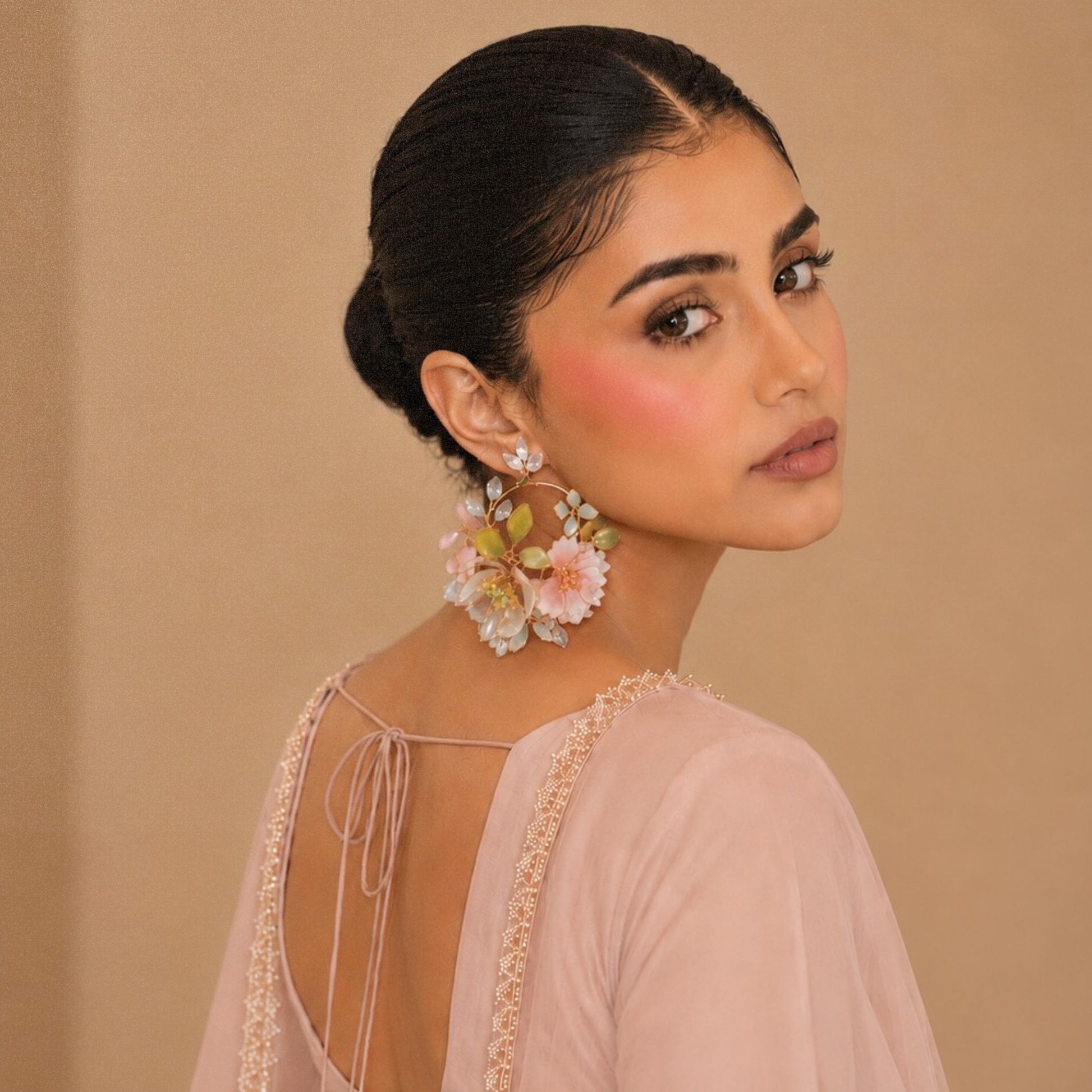 floral handcrafted resin earrings worn by a model in festive wear