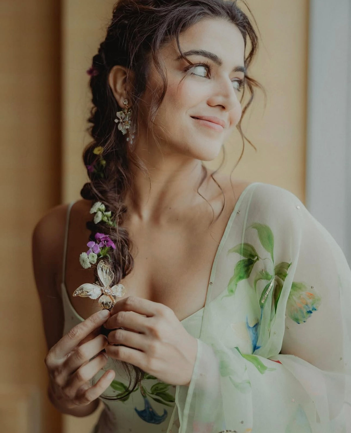 Close view of Wamiqa Gabbi wearing Violet blue floral earrings with green leaf detail
