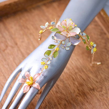 Close-up of Zahara haath phool handcrafted resin florals golden copper wirework on hand white background