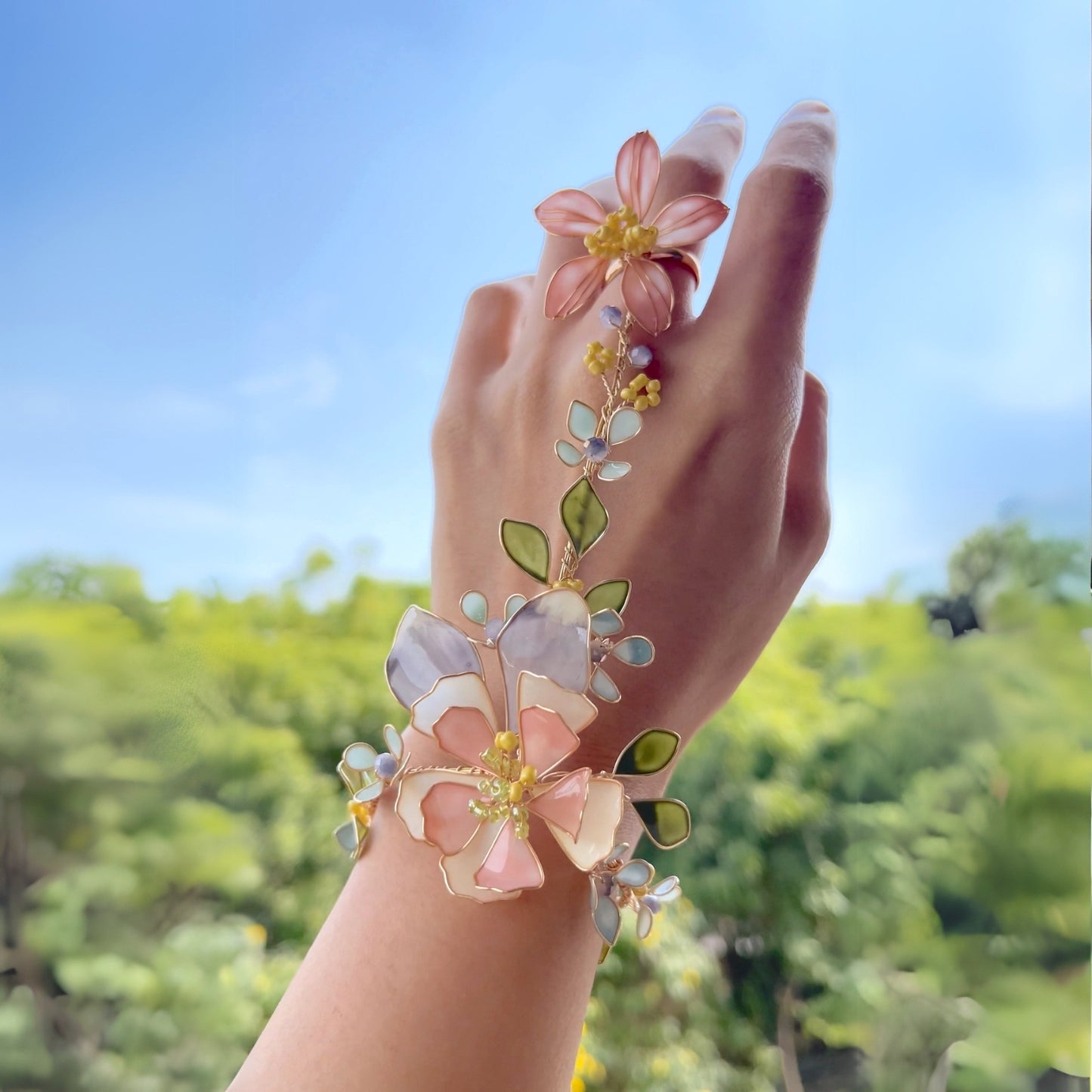 Model wearing Zahara haath phool handcrafted resin floral hand harness outdoors Indian wedding bridal look