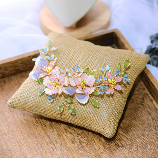Zahara handcrafted resin floral vine necklace blush pink lavender ivory sage green gold on burlap cushion