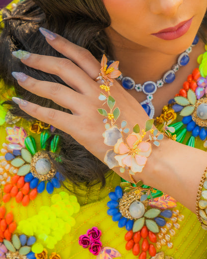 Model wearing Zahara hath phool resin floral hand harness with Indian festive outfit bridal jewellery